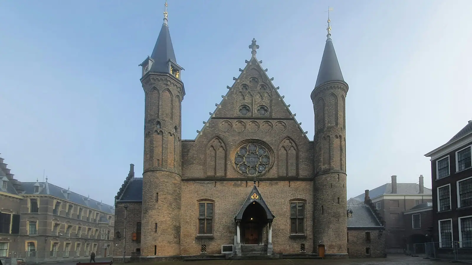 A large building with two towers and a clock