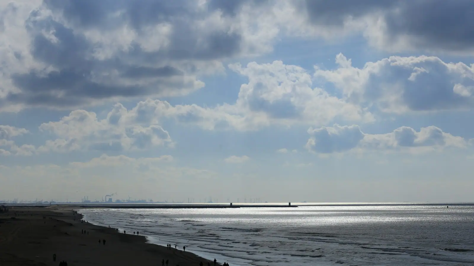 A body of water sitting under a cloudy sky
