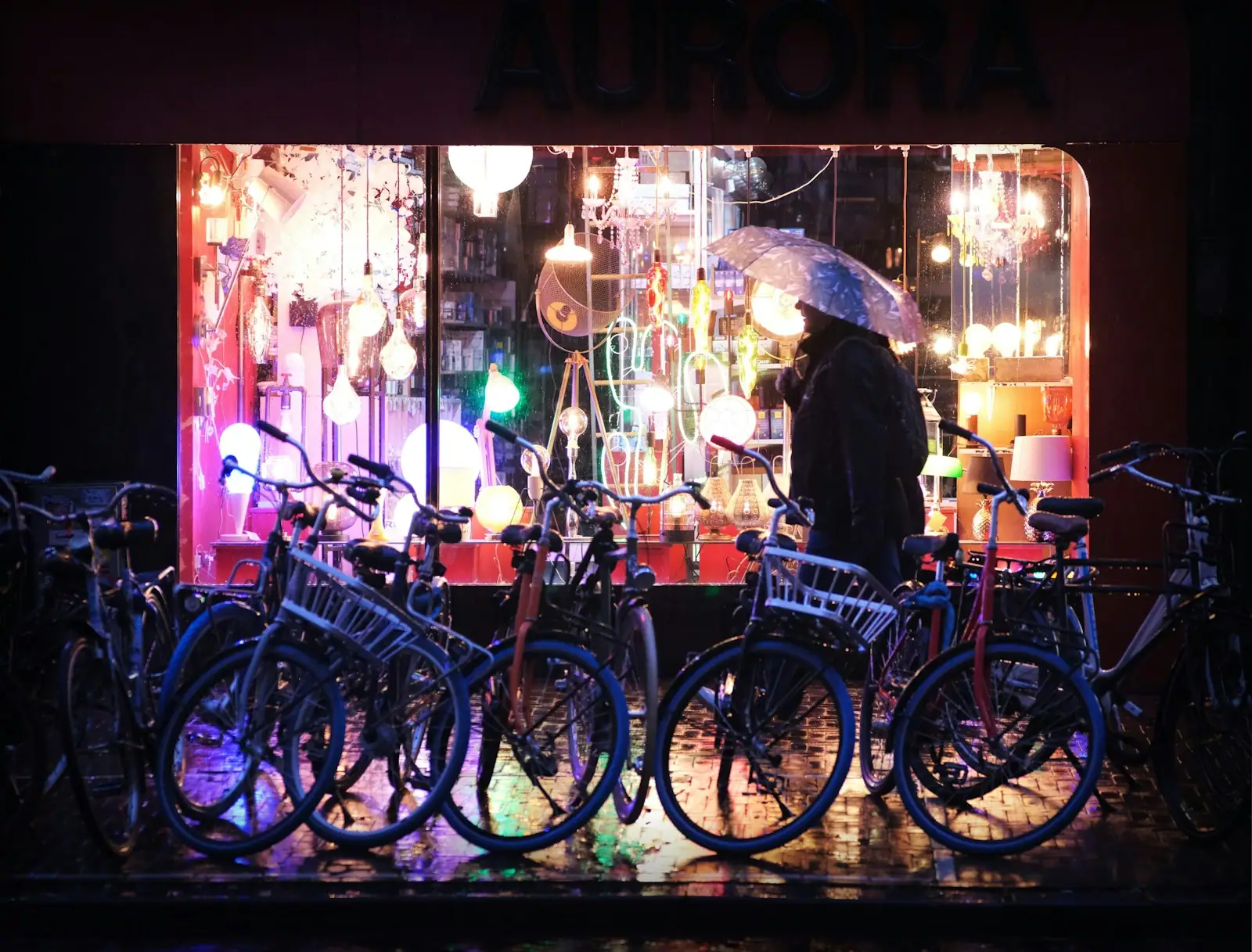 A man standing next to a bunch of bikes