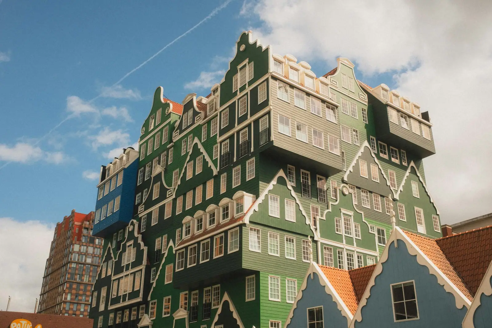 The Inntel Hotel with stacked green traditional Dutch houses in Zaandam