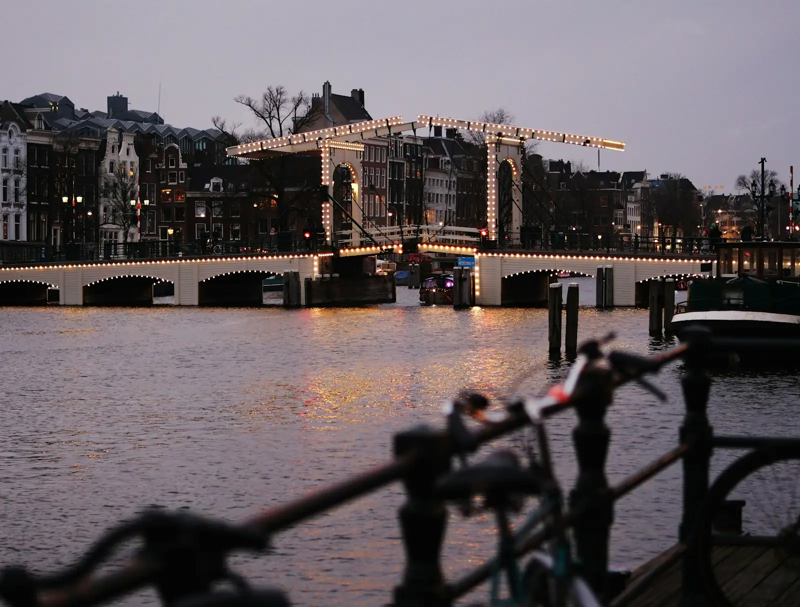 A bridge over a body of water with lights on it