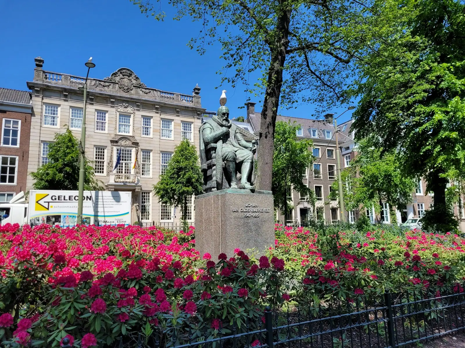 A statue of a man riding a horse in a garden