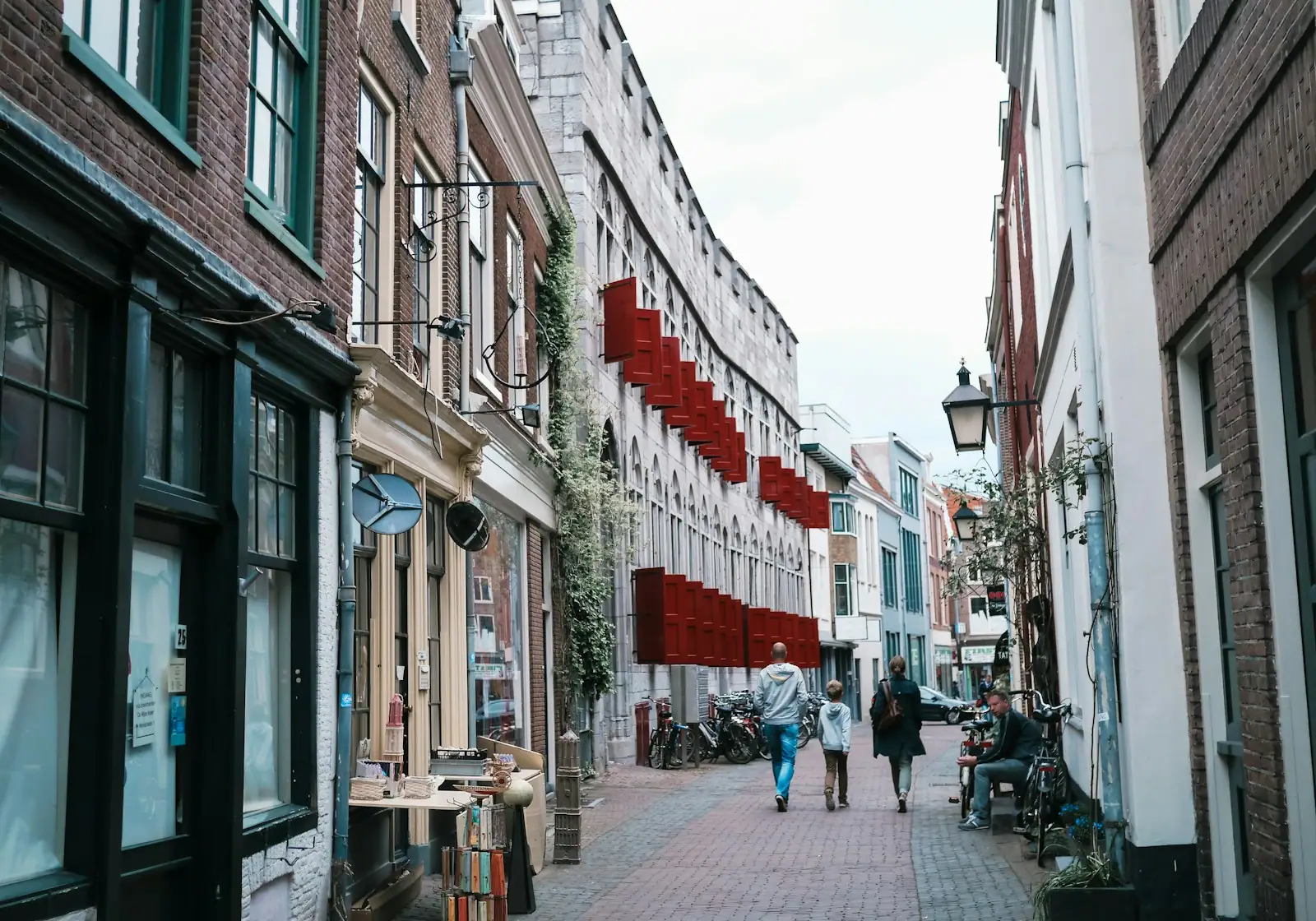 People walking on sidewalk near buildings during daytime