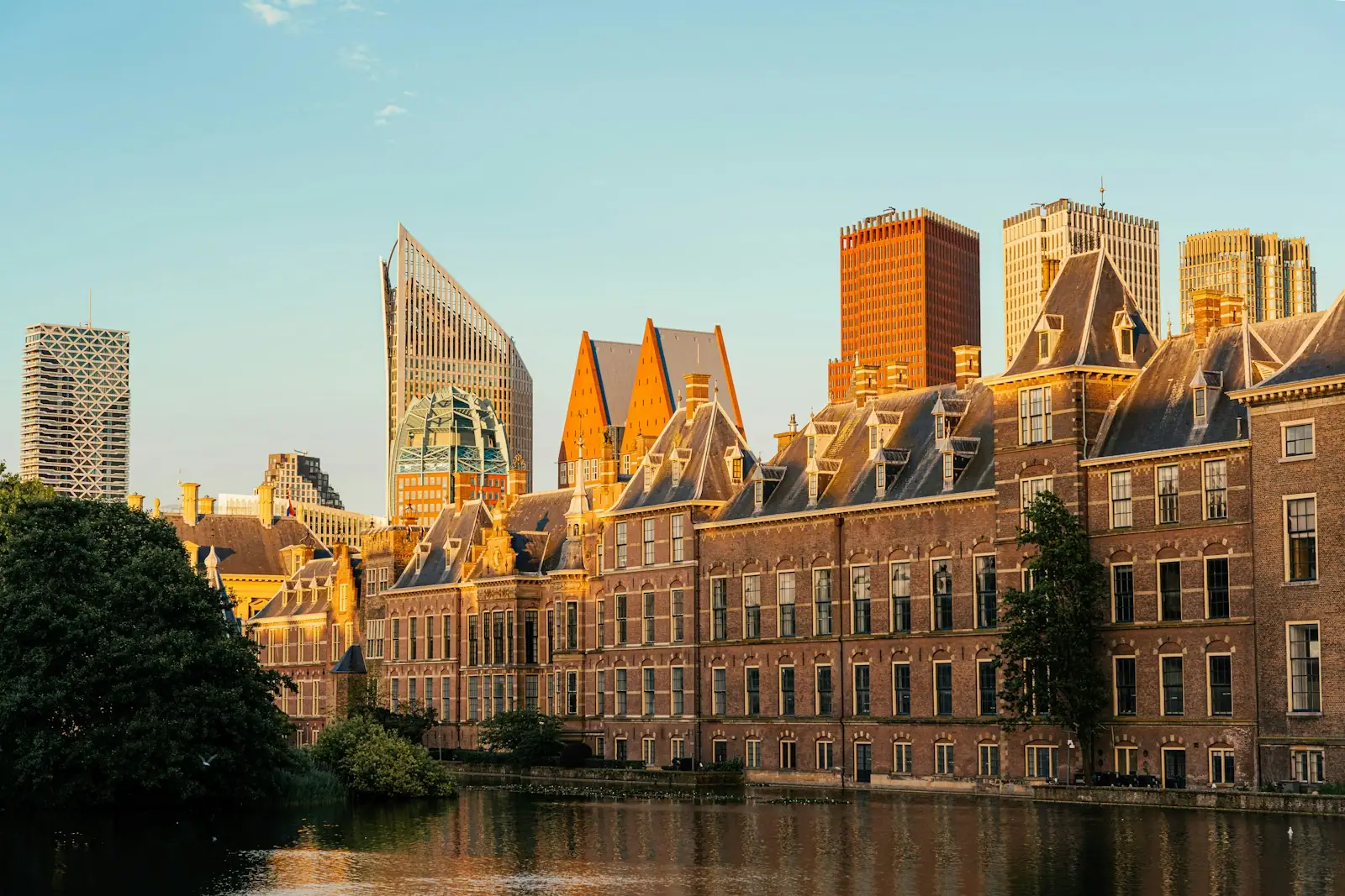 A large building with a lot of windows next to a body of water