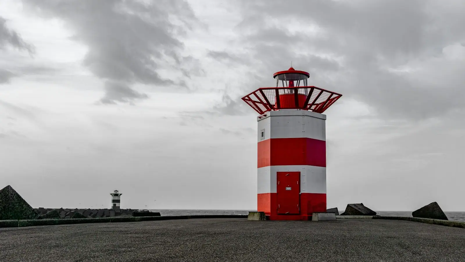 White and red striped lighthouse under white skies