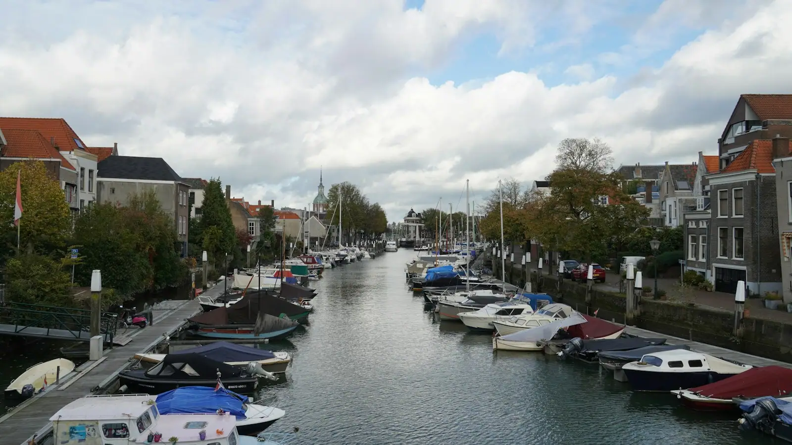 A waterway with many boats parked along the side of it
