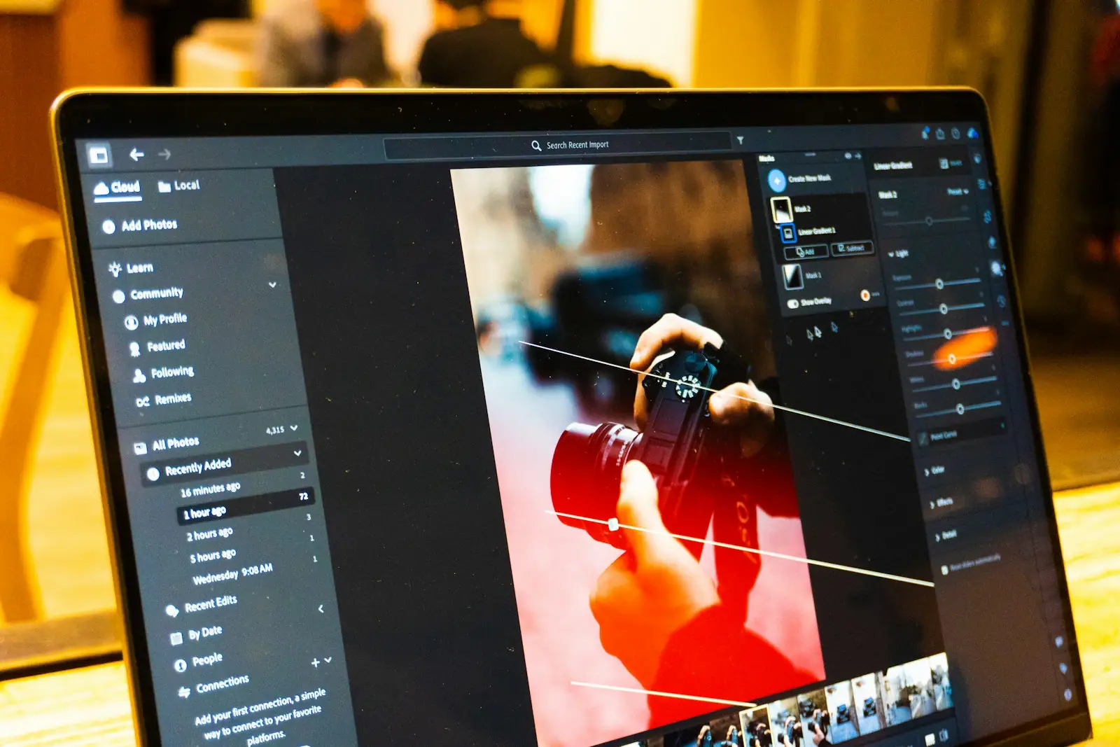 Photo editing software is shown on a laptop screen