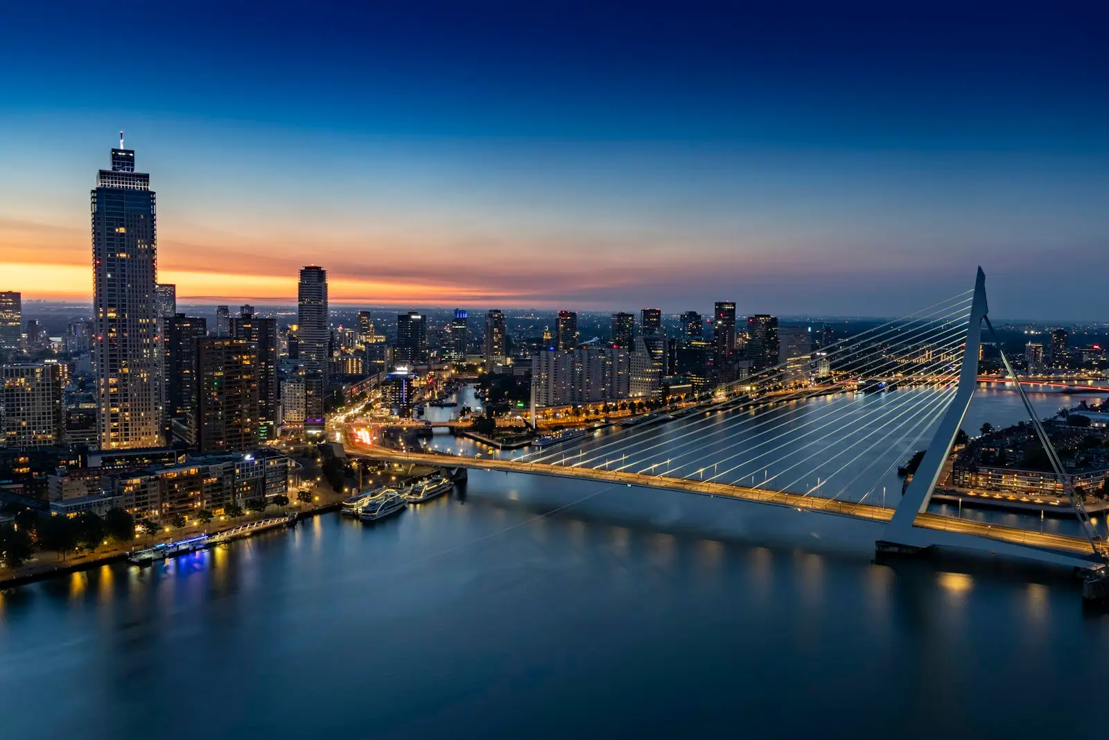 A view of a city and a bridge at night