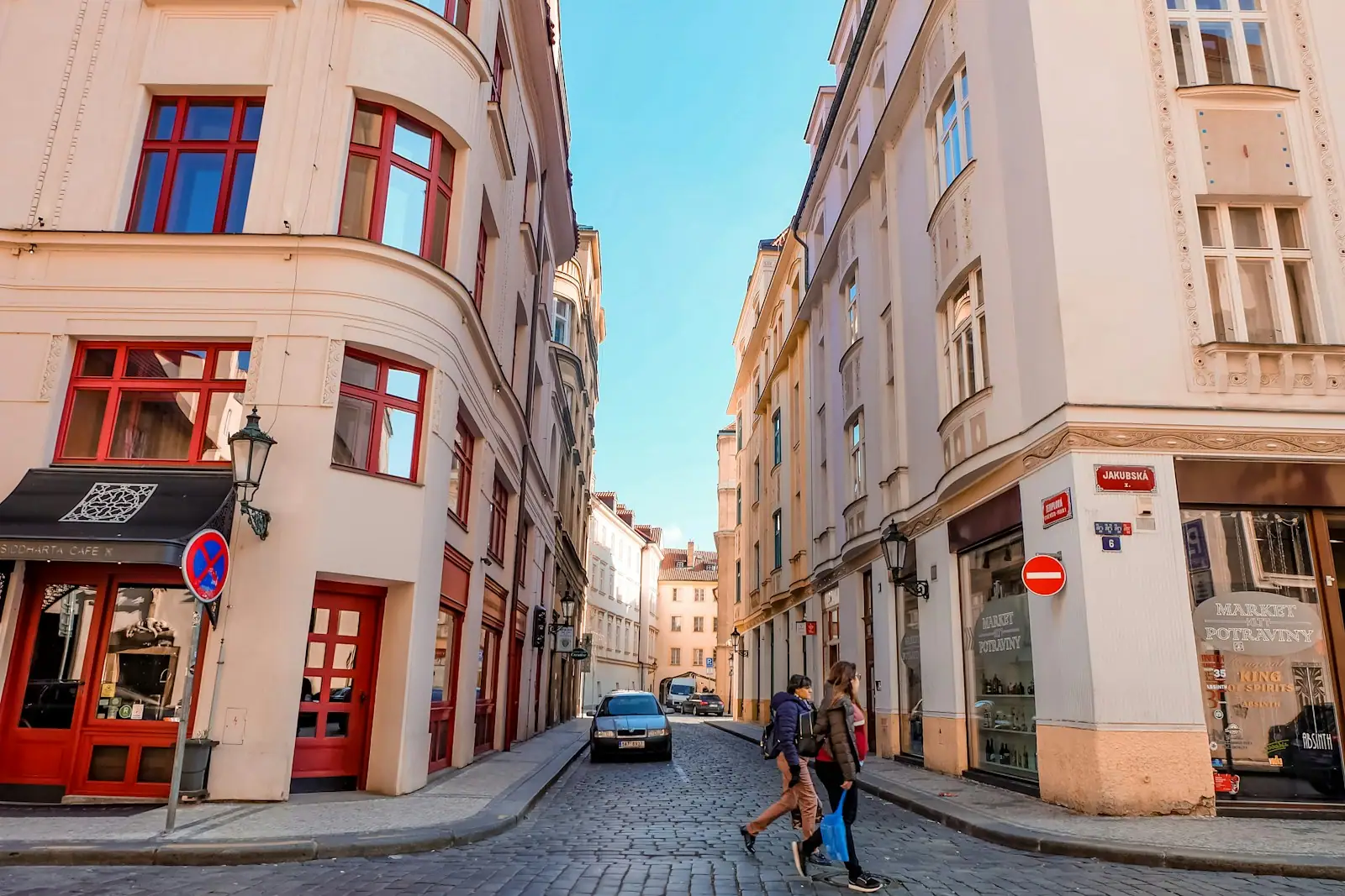 A couple of people that are walking down a street