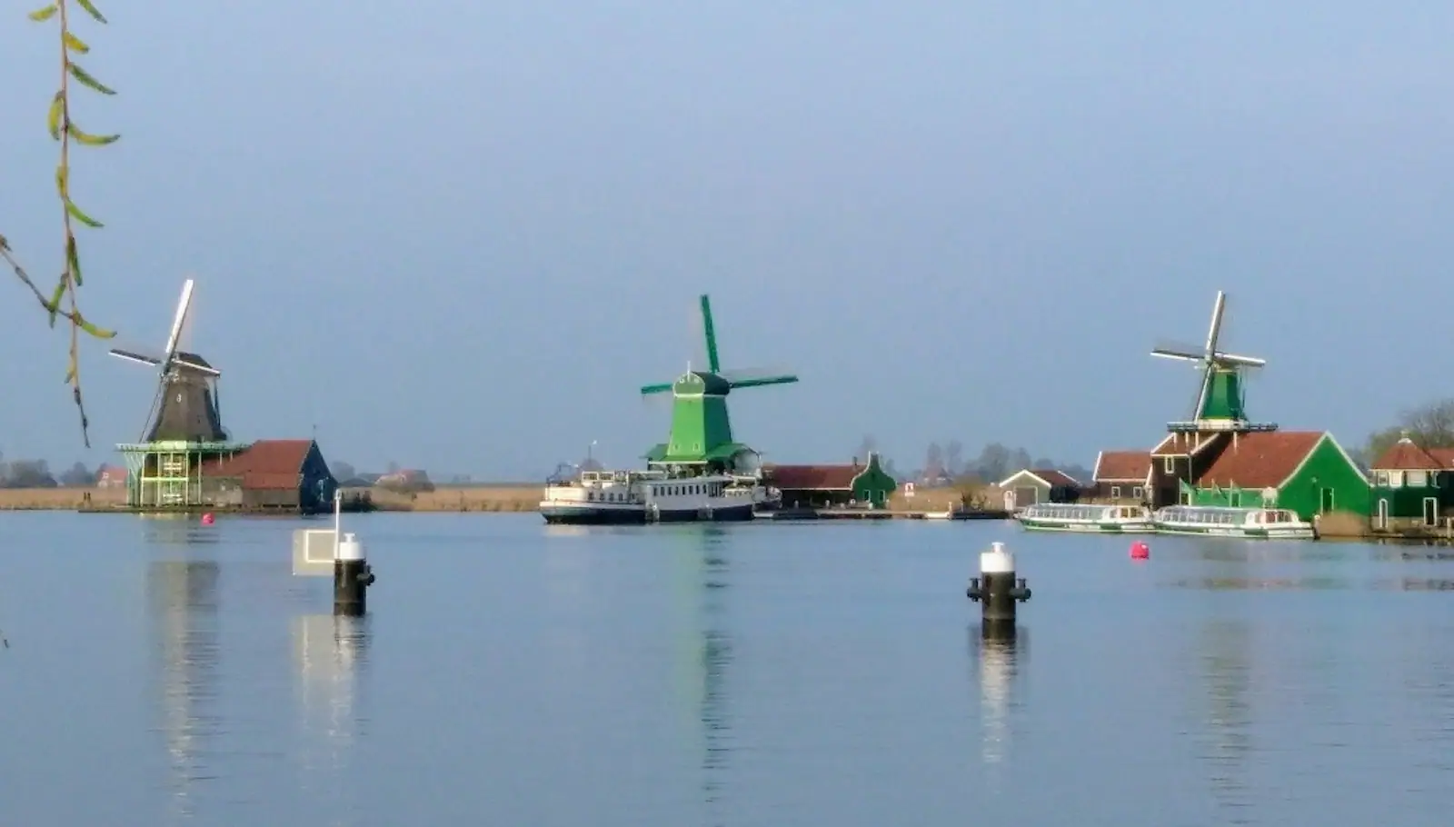 A group of windmills sitting on top of a body of water
