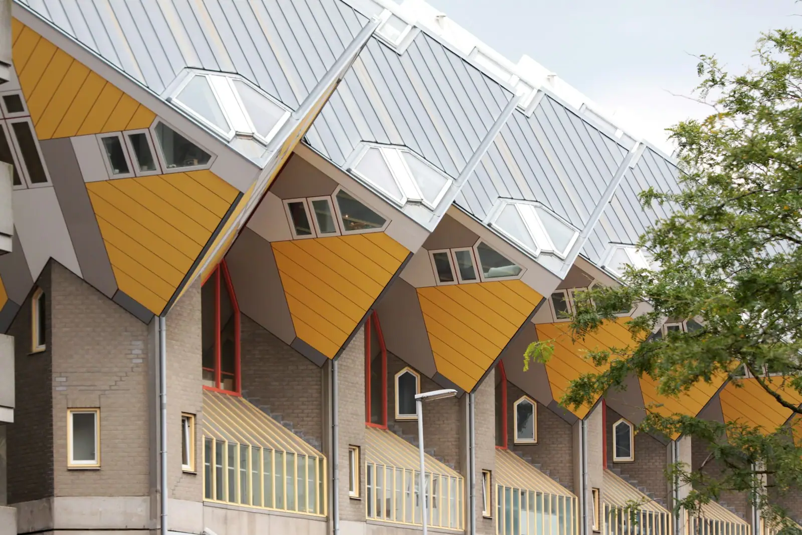 A row of houses with yellow and grey roofing