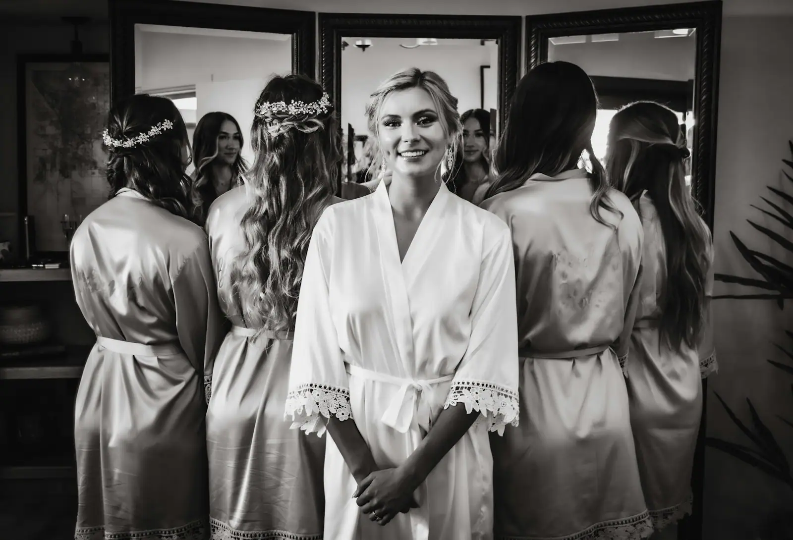 A woman standing in front of a mirror wearing a robe
