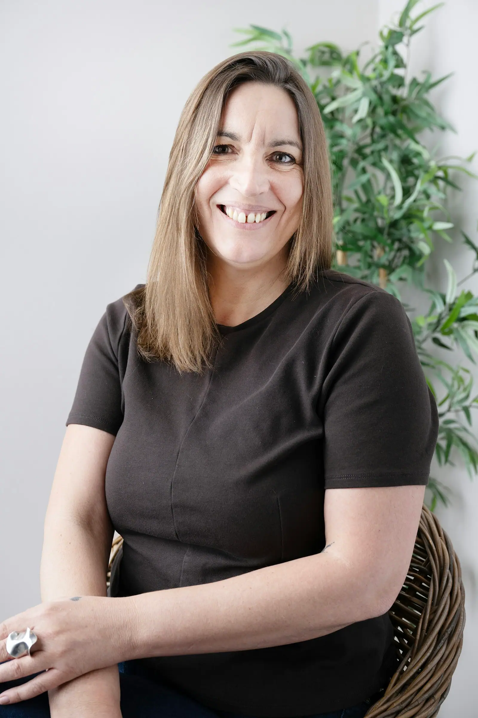 Smiling woman with long hair wearing a dark shirt