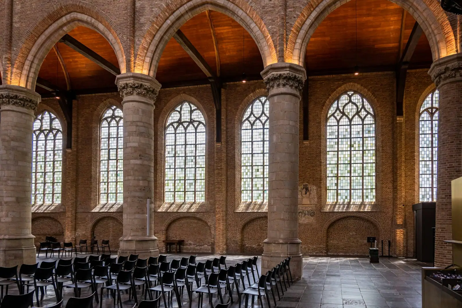 A room with rows of chairs and large windows
