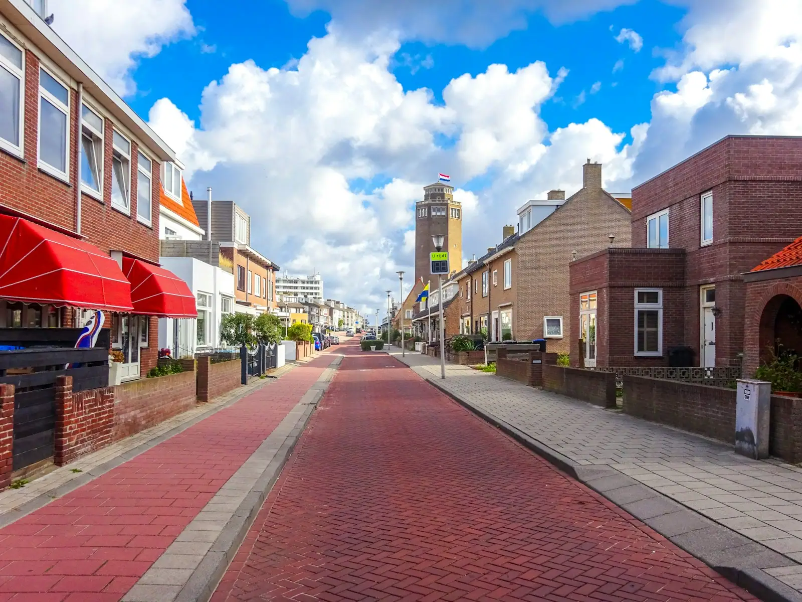 Street with red brick houses and bright blue sky