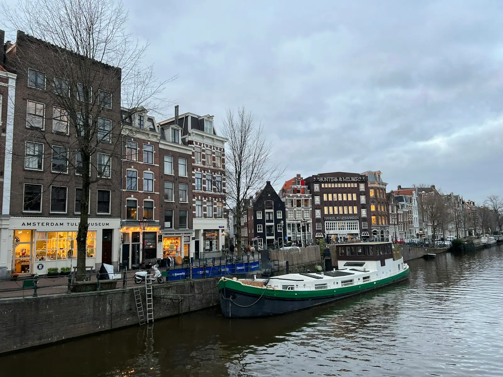 A boat is parked on the side of a river