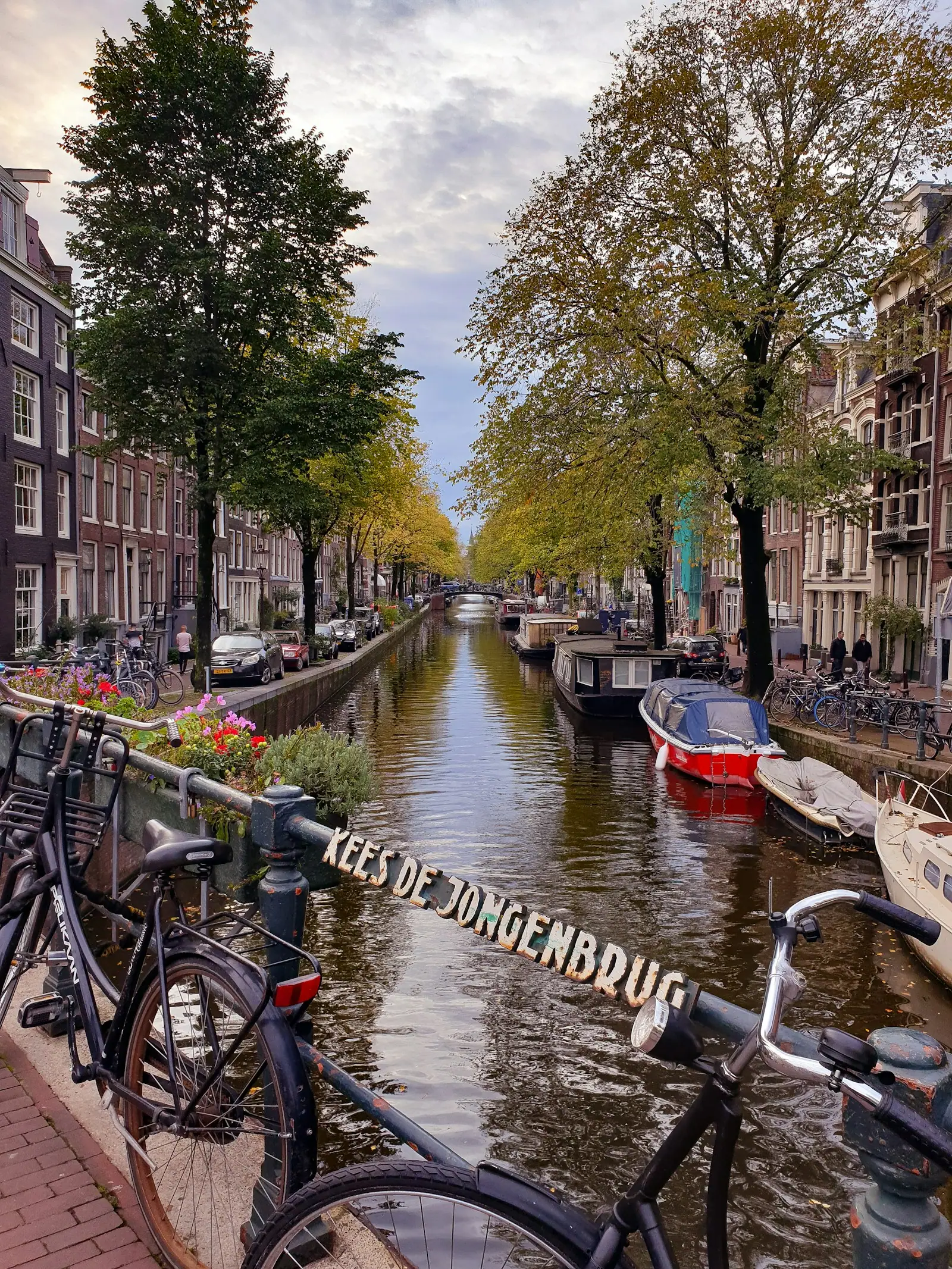 Two blue bicycles parked on bridge in Amsterdam