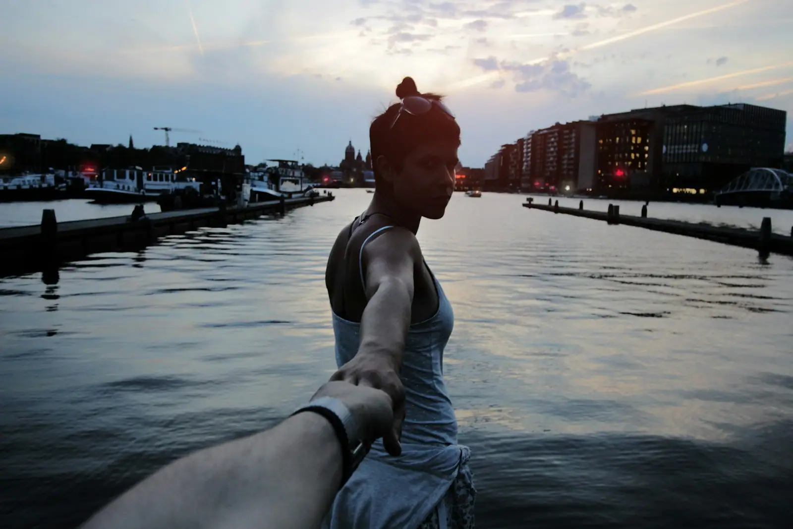 Woman holding person hand taking selfie