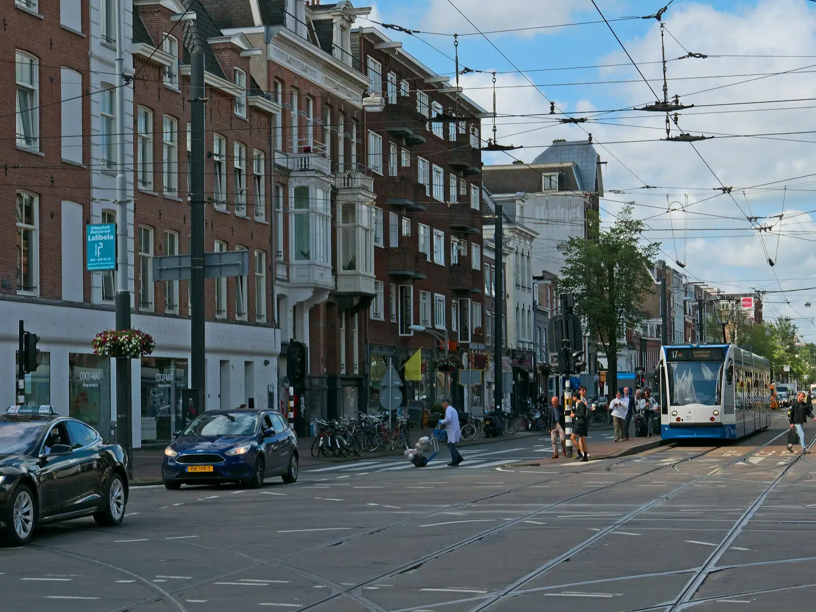 A city street with cars and people