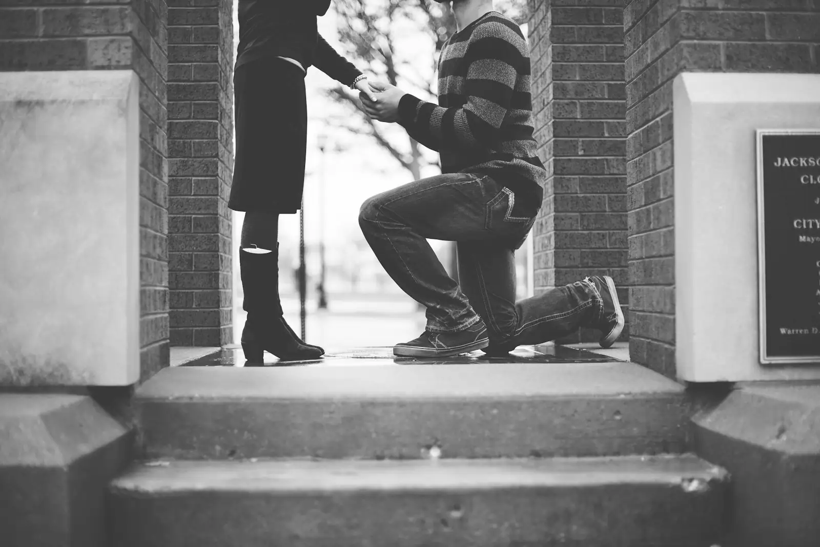 Man kneeling in front of woman