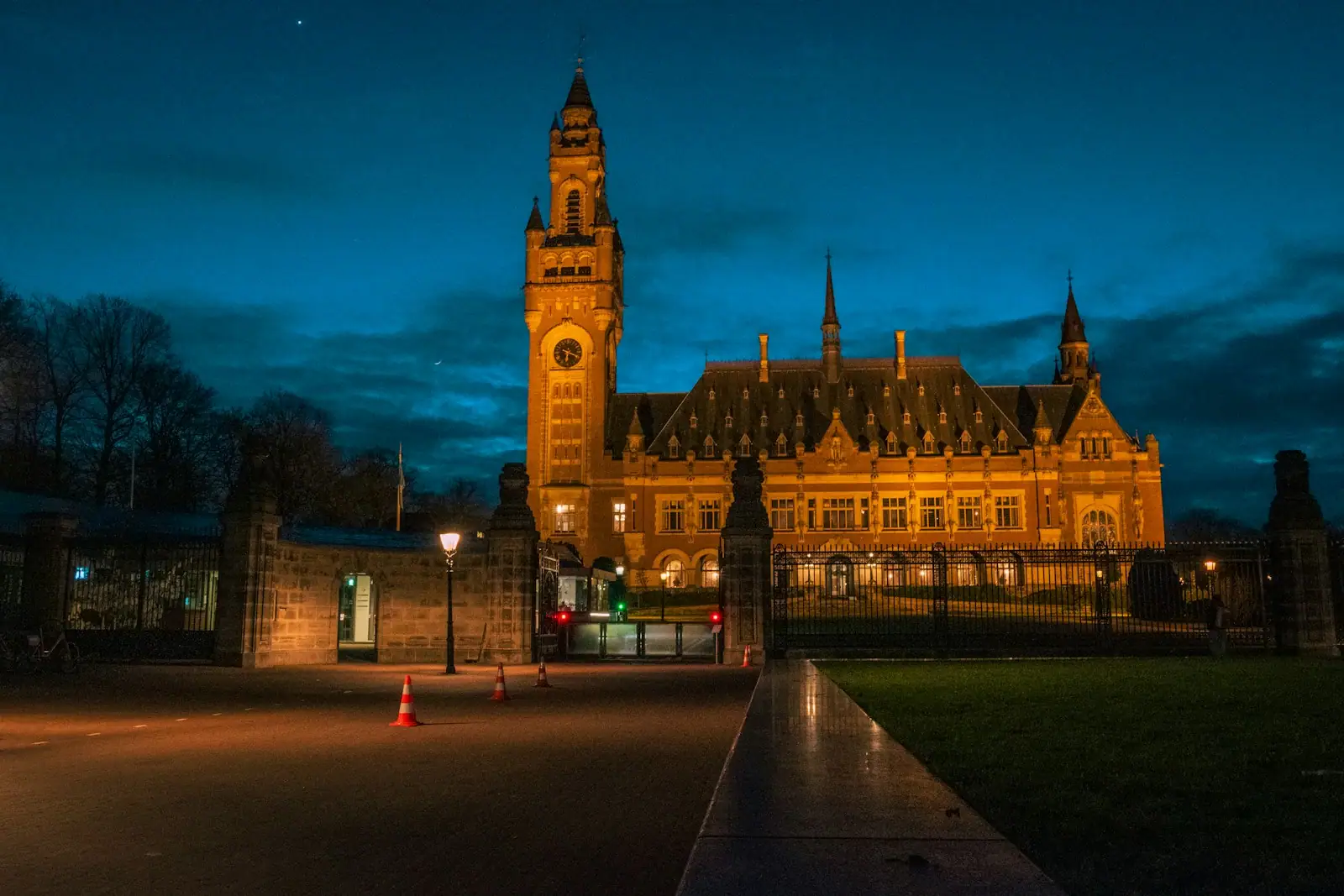 The peace palace glows at dusk in the hague