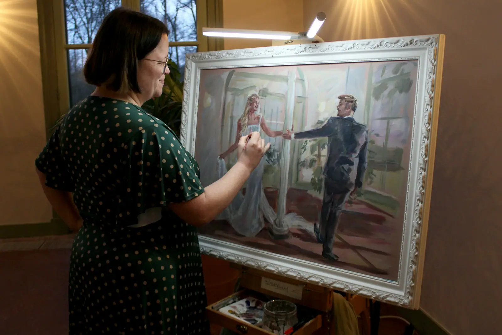Woman painting a portrait of a couple